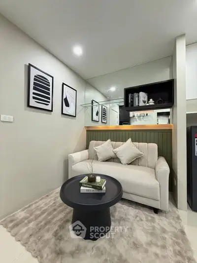 Cozy living room with modern decor, featuring a plush sofa, stylish coffee table, and contemporary wall art.