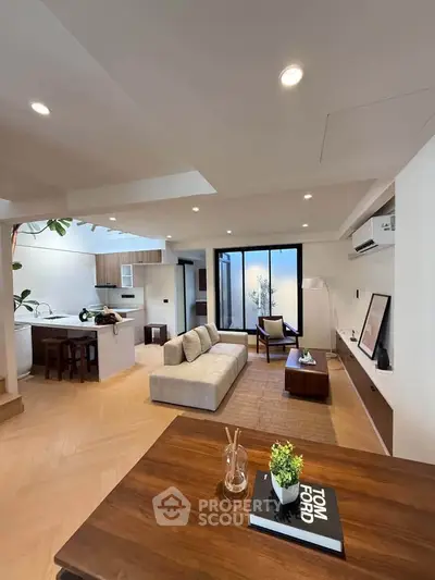 Modern open-plan living room with stylish decor and natural light
