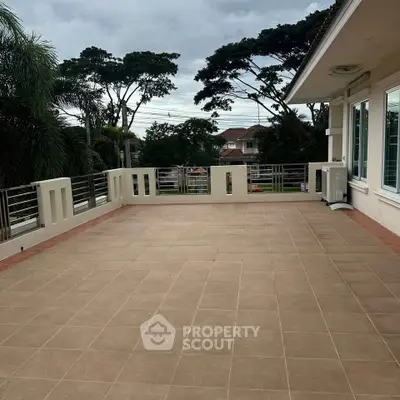 Spacious outdoor balcony with tiled flooring and scenic views, perfect for relaxation and entertainment.