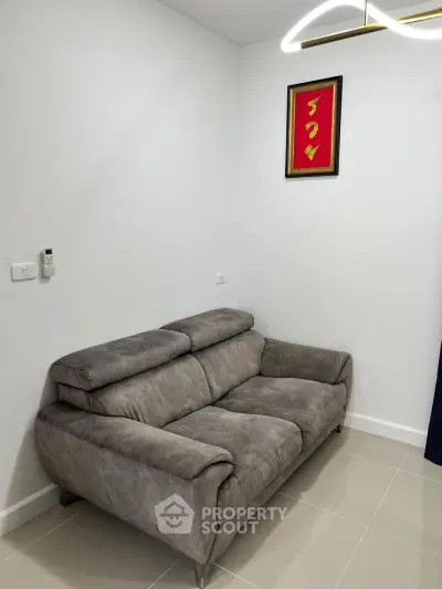Modern living room with stylish gray sofa and elegant wall art