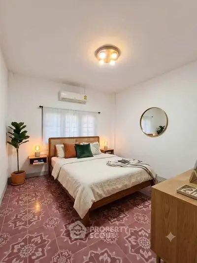 Charming bedroom with stylish decor and patterned floor tiles, featuring cozy lighting and modern furnishings.
