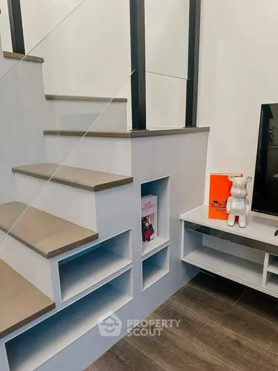 Modern staircase with built-in shelving and stylish decor accents