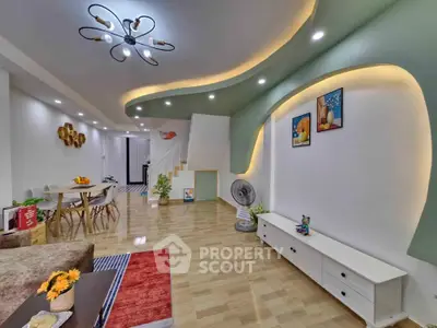 Modern living room with stylish ceiling lights and open layout, featuring elegant decor and spacious design.