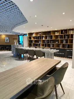 Modern co-working space with stylish furniture and bookshelves, ideal for productivity and collaboration.