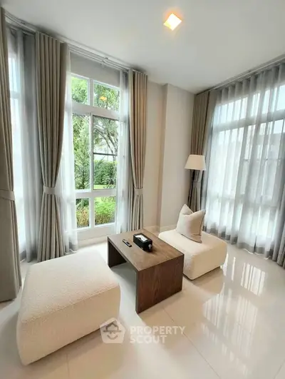 Bright and airy living room with large windows and modern furniture