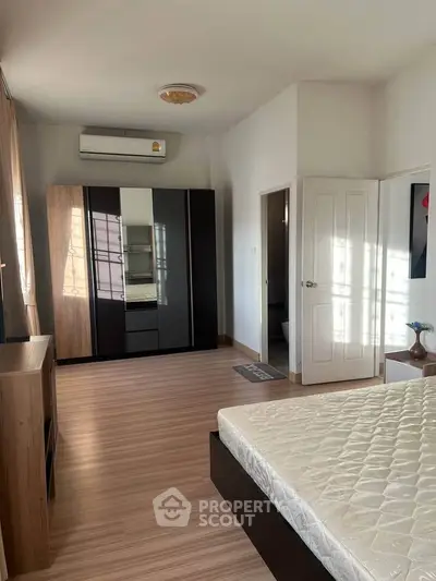 Spacious bedroom with modern wardrobe and natural light