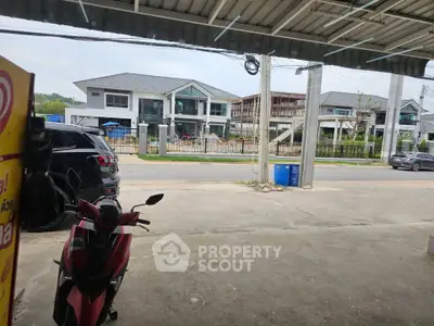 Modern residential neighborhood with contemporary houses and parked vehicles, showcasing suburban living.