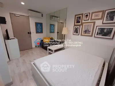 Modern bedroom with stylish decor and wall art in a cozy apartment for sale in Bangkok.