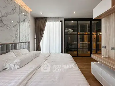 Luxurious modern bedroom with marble accent wall and spacious layout.