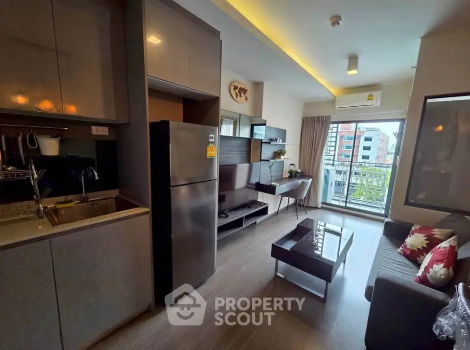 Modern living room with sleek kitchen and balcony view in urban apartment