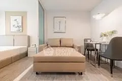 Modern studio apartment with cozy living area and dining space
