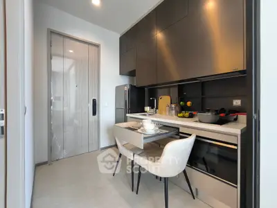 Modern kitchen with sleek cabinets and dining setup in a stylish apartment.