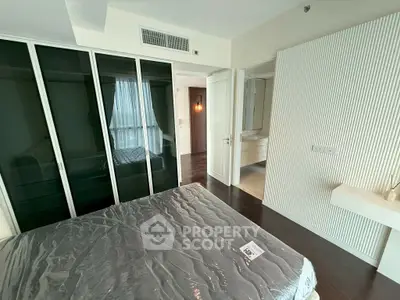 Modern bedroom with sleek design and large wardrobe in a stylish apartment.