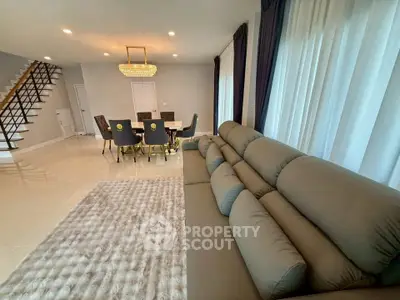 Luxurious living room with elegant dining area and plush seating.