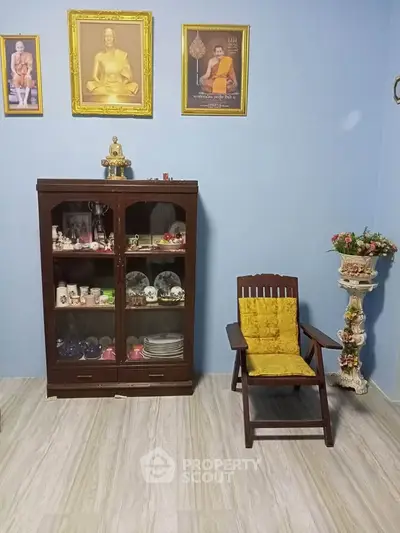 Charming living room with vintage decor and elegant display cabinet.