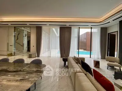 Luxurious modern living room with marble floors and pool view