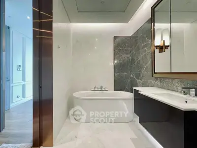 Luxurious modern bathroom with elegant marble finishes and stylish fixtures.