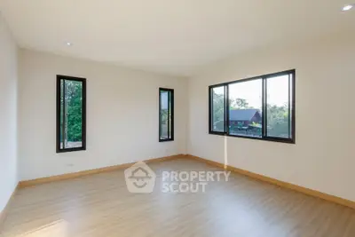 Spacious empty room with large windows and scenic view, perfect for customization.