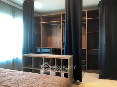 Spacious bedroom with elegant walk-in closet and natural light