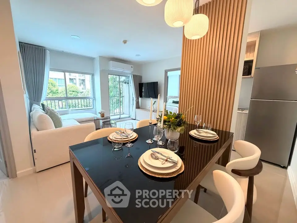 Modern open-plan living and dining area with elegant decor and natural light.