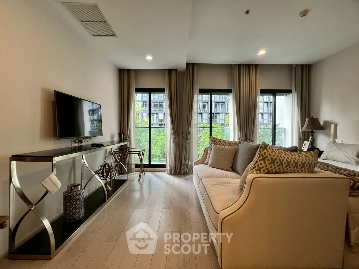 Modern living room with elegant decor and large windows offering a scenic view of the city.