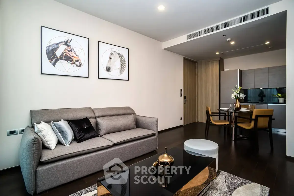 Modern living room with stylish decor and open kitchen layout in luxury apartment.