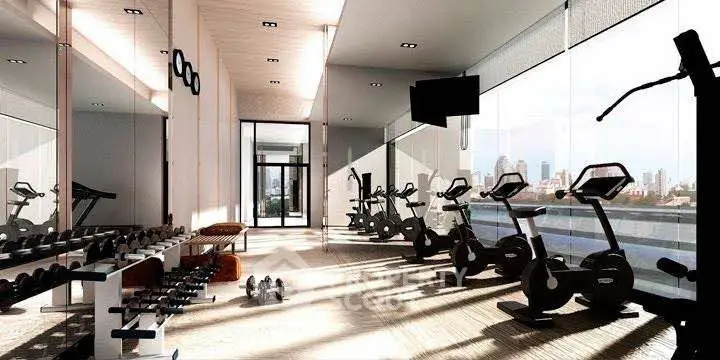 Luxurious gym with modern equipment and city view in upscale residential building.