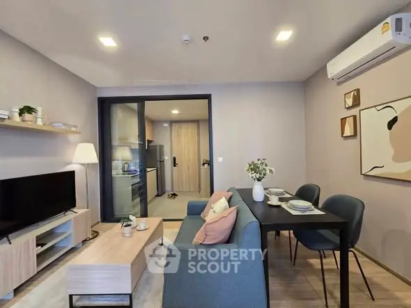 Modern living room with stylish furniture and open kitchen layout, perfect for urban living.