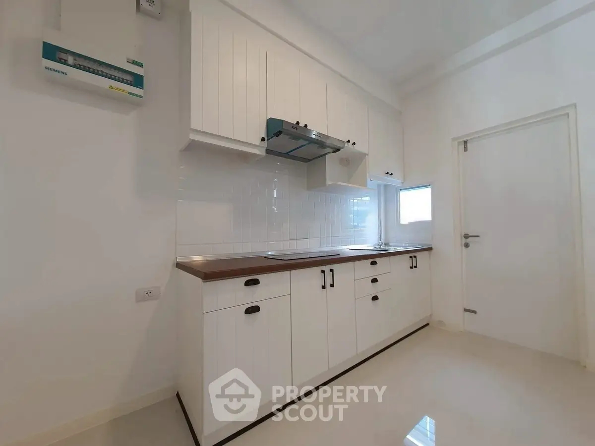 Modern kitchen with sleek white cabinets and minimalist design