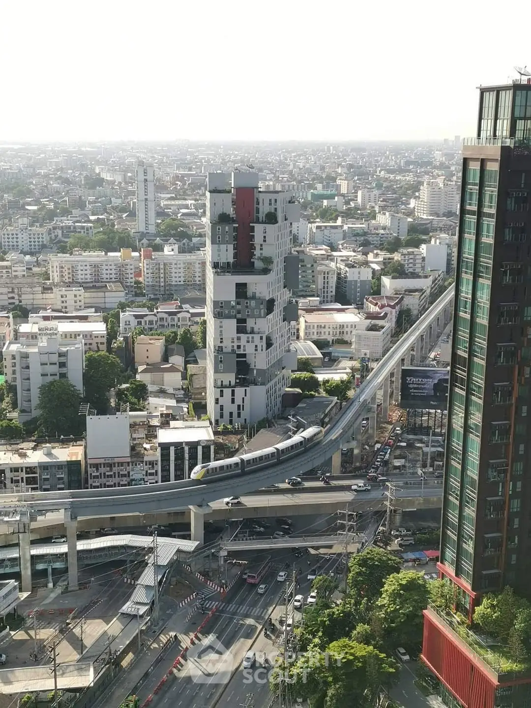 Stunning cityscape view with modern high-rise buildings and elevated train track.