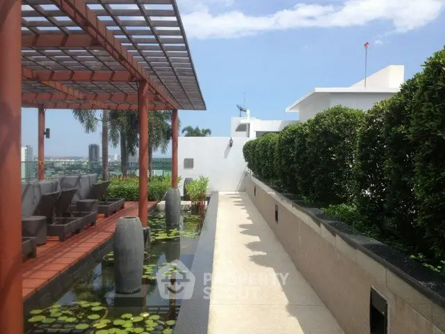 Luxurious rooftop garden with modern pergola and water feature offering stunning city views.