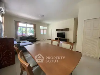 Spacious living room with modern furniture and large windows