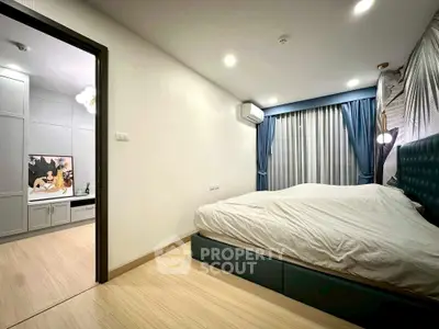 Modern bedroom with stylish decor and adjacent study area