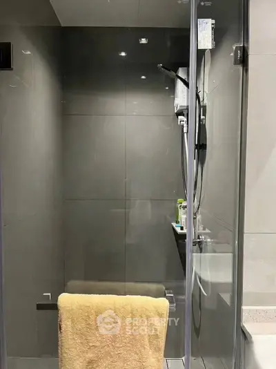 Modern bathroom with sleek glass shower and contemporary fixtures.