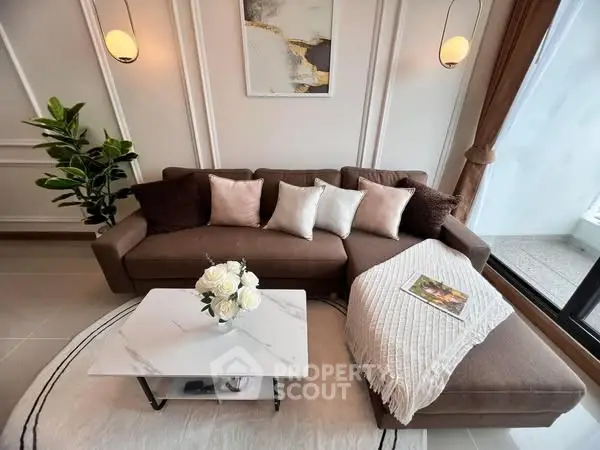 Elegant living room with modern sofa, marble coffee table, and stylish decor.
