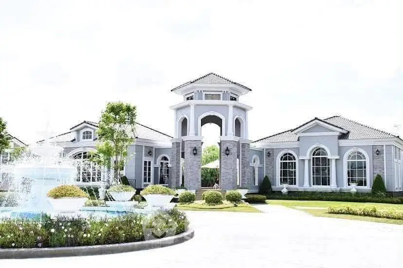 Luxurious estate with grand entrance and elegant fountain in lush landscaped garden.