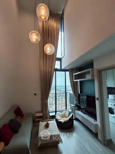 Modern living room with high ceilings and large windows offering stunning city views.