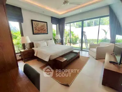 Luxurious bedroom with garden view, featuring modern decor and ample natural light.