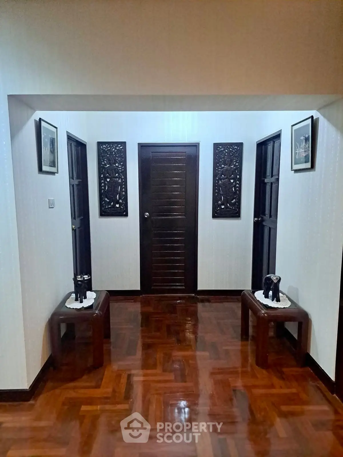 Elegant hallway with polished wooden floors and decorative accents in a luxurious home.