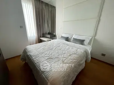 Cozy bedroom with elegant decor and natural light, featuring a comfortable bed and stylish curtains.