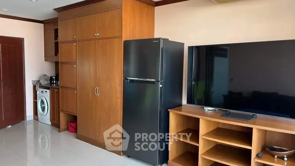 Spacious living area with modern appliances and sleek wooden cabinetry