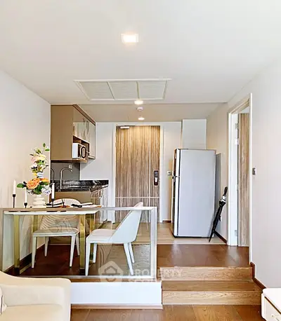 Modern open-layout kitchen and dining area with sleek design and natural lighting.