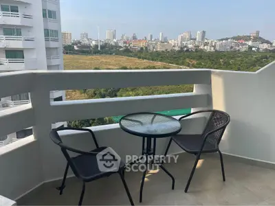 Charming balcony with city view and outdoor seating in modern apartment
