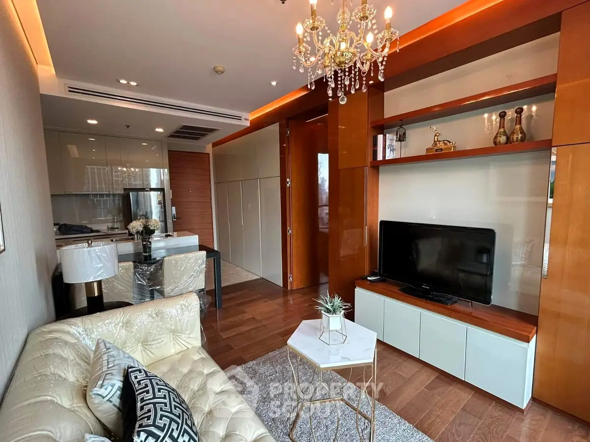 Luxurious living room with elegant chandelier and modern decor in upscale apartment.