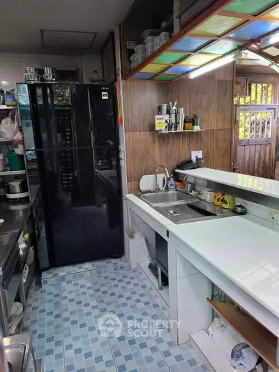 Charming kitchen with modern appliances and colorful tile flooring, perfect for culinary enthusiasts.