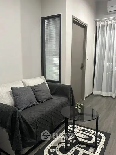 Modern living room with cozy sofa and stylish decor in a contemporary apartment.