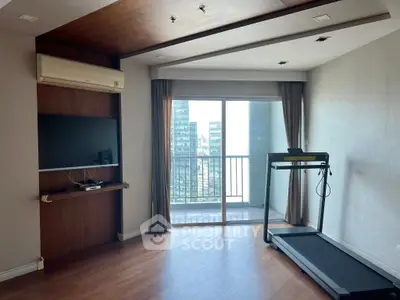 Spacious living room with treadmill and balcony view in modern apartment