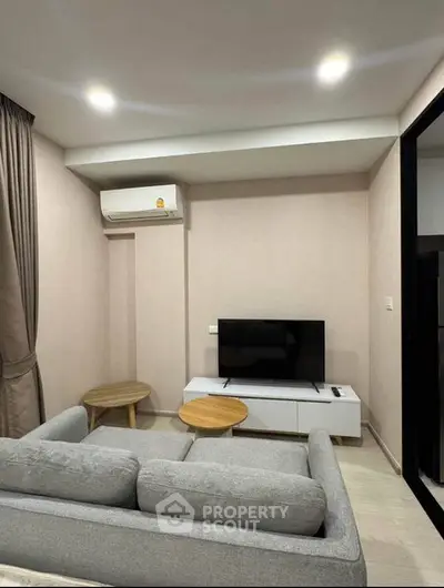 Modern living room with sleek furniture and wall-mounted TV, perfect for cozy relaxation.