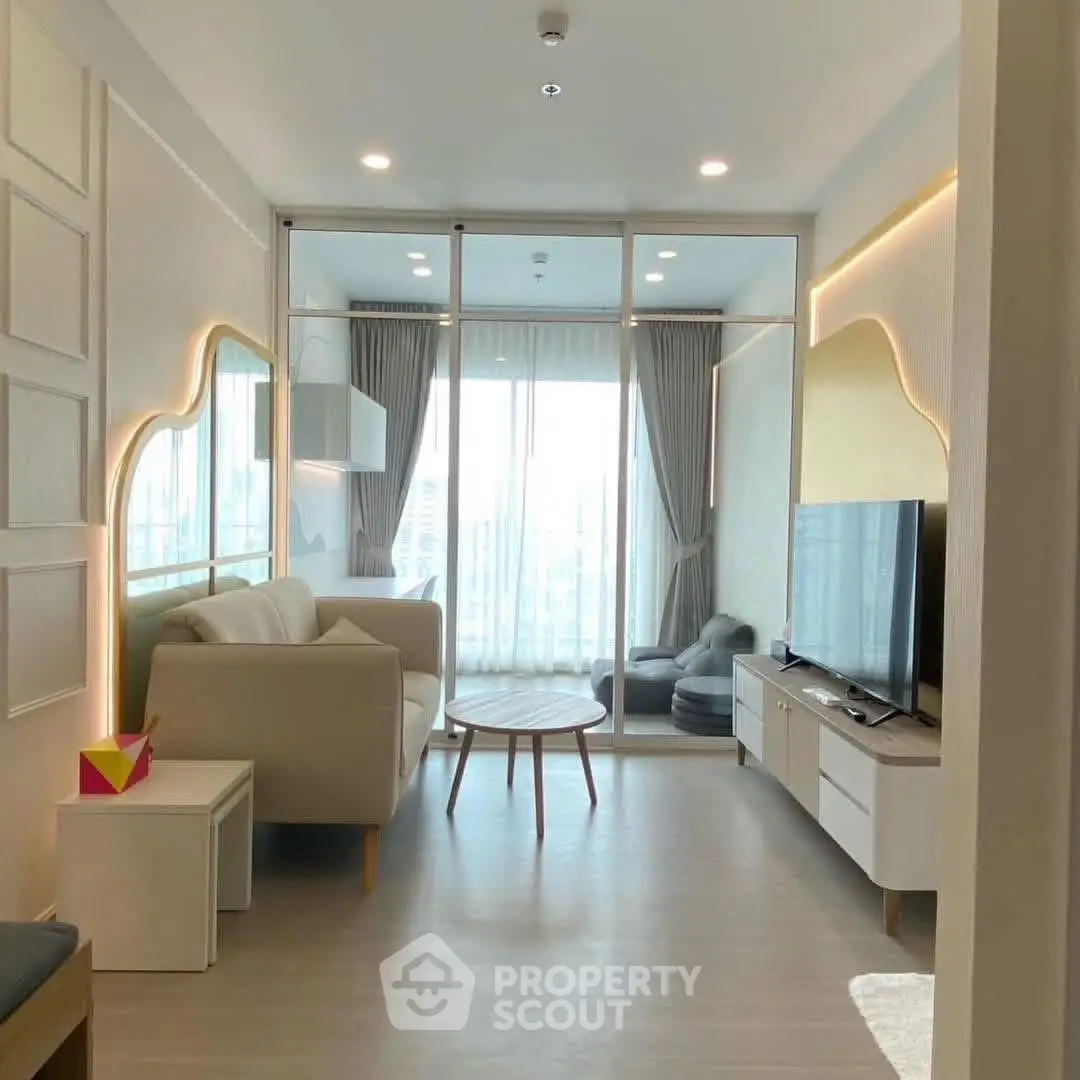 Modern living room with stylish decor and large windows offering natural light.
