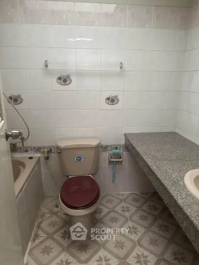 Cozy bathroom with vintage tiles and built-in bathtub, ideal for renovation projects.